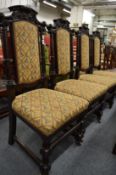 A set of four oak framed high back dining chairs.