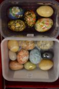 Decorative hard stone and papier mache and other eggs.