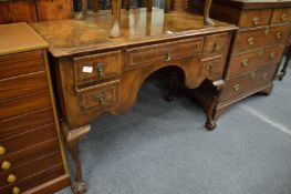 A George II design walnut low boy with a regiment of five drawers on carved cabriole legs with