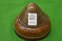 A paperweight made from the tip of an artillery shell.