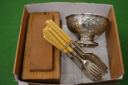 Plated bowl, flatware and a sharpening stone.