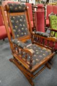 A Victorian walnut American style rocking armchair.