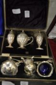 Two cased sets of silver cruets.