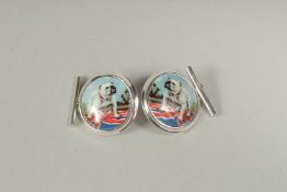 A pair of silver bulldog cufflinks in a box.