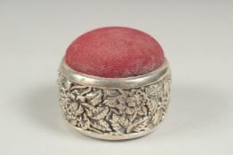 A silver embossed circular fruiting vine pin cushion, 4.5cm.