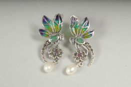 A pair of silver plique enamel dragonfly earrings in a box.