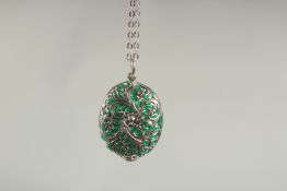 A silver and enamel lily of the valley locket and chain in a box.