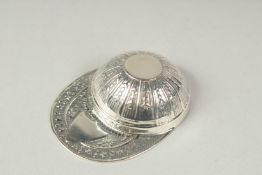 A silver jockeys cap caddy spoon.