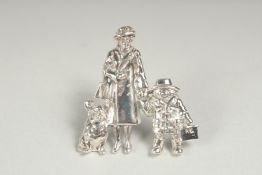 A silver brooch Queen Elizabeth II, Paddington Bear and corgi in a box.