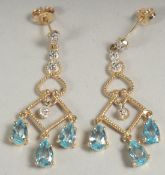 A pair of 9ct. gold blue topaz and diamond chandelier drop earrings in a box.