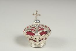 A silver crown pin cushion.