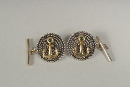 A pair of silver anchor and rope cufflinks in a box.