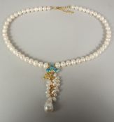 A silver gold plated pearl blue topaz necklace in a box.