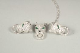 A silver panther pendant and chain and pair of earrings in a box.