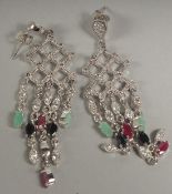 A pair of silver ruby sapphire and emerald chandelier drop earrings in a box.