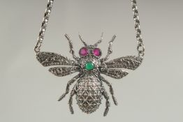 A heavy silver bee necklace and chain in a box.