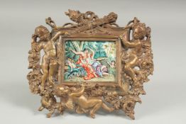 A bronze cherub frame with an enamel plaque, 15 cm x 16cm.