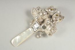 A silver double teddy bear rattle.