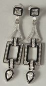A pair of silver art Deco style cubic zirconia and enamel drop earrings in a box.