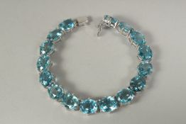 A silver London blue topaz line bracelet in a box.