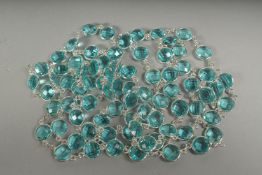 A long silver blue topaz chain in a box.