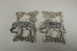 A pair of silver plated wine labels whisky and brandy.