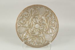AN ISLAMIC SILVER INLAID BRASS DISH, 35cm diameter.
