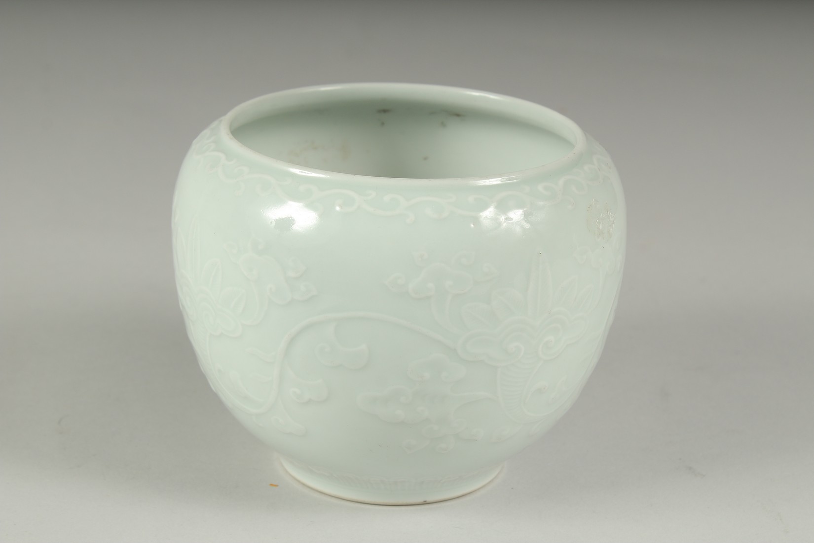 A CHINESE REPUBLIC PERIOD WHITE CELADON PORCELAIN POT, with carved ruyi stylised foliate decoration, - Image 3 of 7