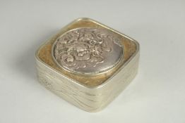 A SMALL SIGNED JAPANESE WHITE METAL AND BRASS BOX, the hinged lid with relief dragon roundel, 5cm