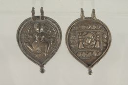TWO 19TH CENTURY INDIAN SILVER PENDANTS, one depicting Ganesh, the other depicting another deity,
