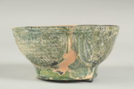A RARE 8TH - 9TH CENTURY UMAYYAD GREEN GLAZED POTTERY BOWL, 12.5cm diameter.