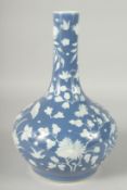 A CHINESE BLUE GROUND PORCELAIN VASE, with carved floral decoration in white, 34cm high.