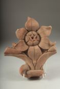 A FINE 17TH CENTURY MUGHAL INDIAN CARVED RED STONE FLOWER, 26cm high.