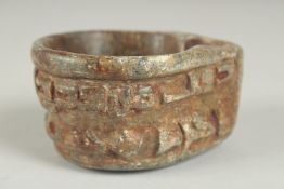 A FINE EARLY ISLAMIC CARVED STONE OIL LAMP with Kufic calligraphy.