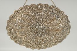 A 19TH CENTURY OTTOMAN EMBOSSED SILVER MIRROR, with relief floral decoration and hanging chain, 30.