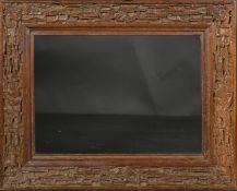 AN EARLY 20TH CENTURY CHINESE HARDWOOD FRAME, carved in an intricate design with bats and dragons,