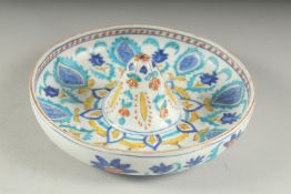 A TURKISH KUTAHYA GLAZED POTTERY LEMON SQUEEZER, 18.5cm diameter.