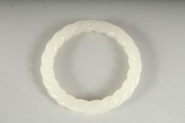 A CHINESE WHITE TWIST JADE BANGLE. 3ins diameter.