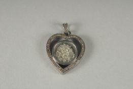 A 18CT GOLD DIAMOND SET HEART PENDANT.