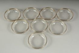 A SET OF EIGHT CONTINENTAL GLASS BOWLS with silver bands, .800. 4ins diameter.