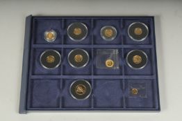 A TRAY OF 10 VARIOUS SMALL GOLD COINS.