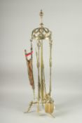 A GOOD BRASS FIRESIDE SET, COMPLETE, with tongs, bellows, brush, poker and shovel. 37ins high.