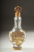 A SUPERB GLASS AND GOLD OVERLAY SCENT BOTTLE AND STOPPER with three enamel flowers. 12.5cm long.