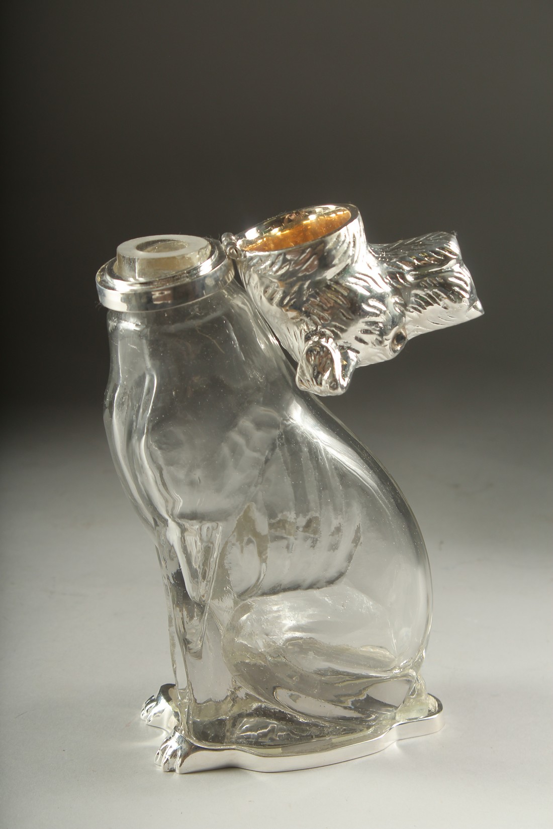 A GLASS CLARET JUG formed as a dog with silver plated head. 8ins high. - Image 2 of 2