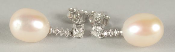 A SUPERB PAIR OF 18CT WHITE GOLD PEARL AND DIAMOND DROP EARRINGS in a box.