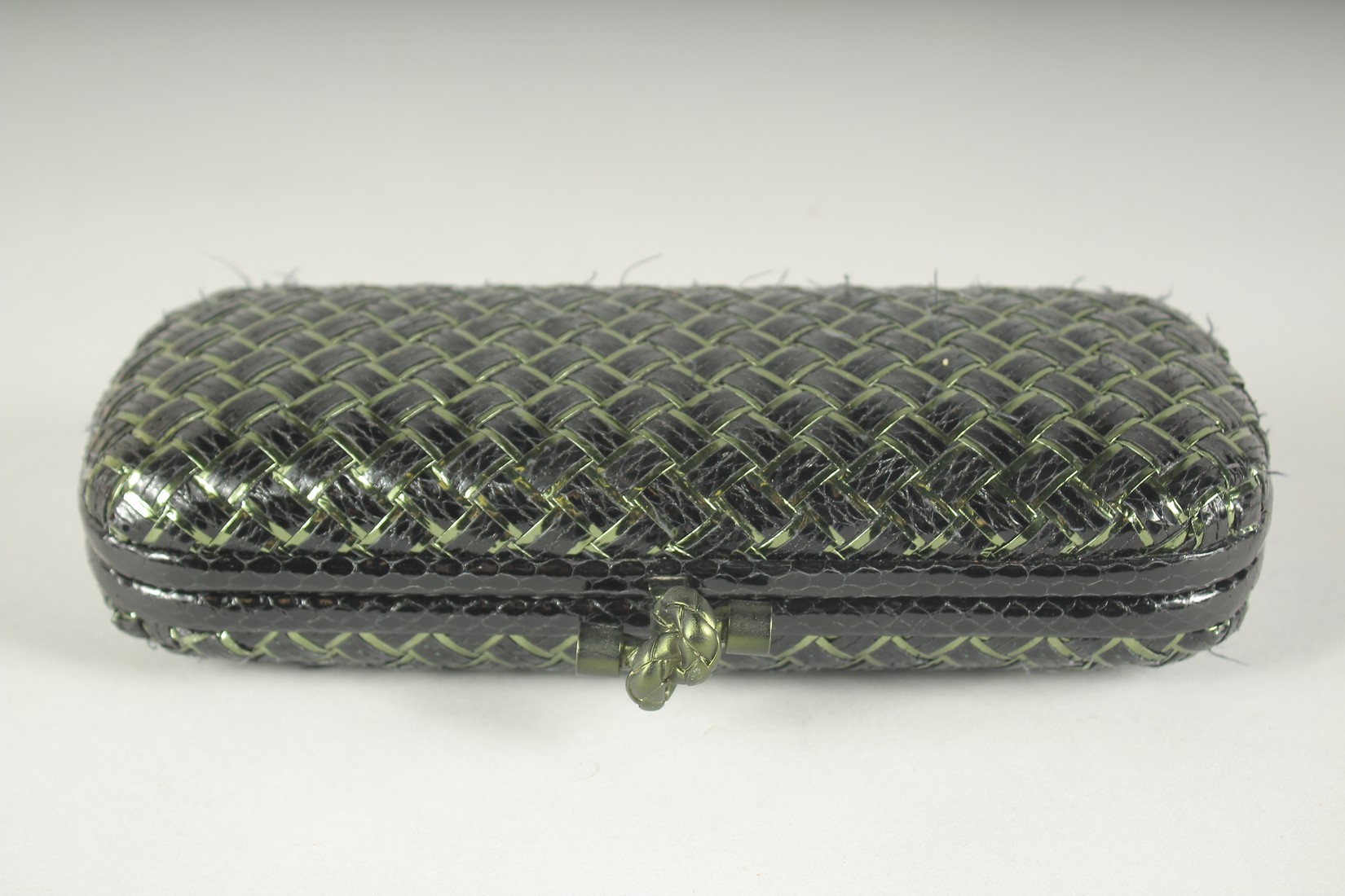 BOTTEGA VENETO. A BLACK AND GILT WOVEN CLUTCH BAG. 9.5ins long.