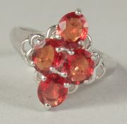 AN 8CT WHITE GOLD FOUR STONE RUBY RING in a box.