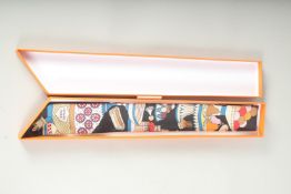 A HERMES SILK TIE in a box.
