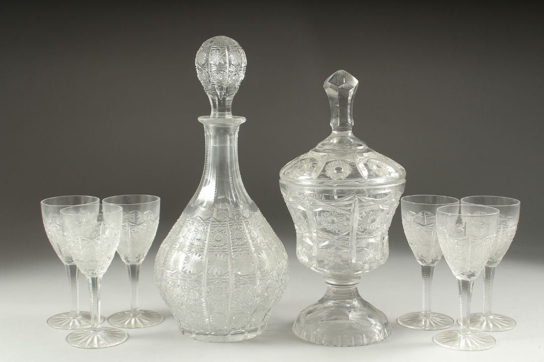 A GOOD CUT GLASS SHERRY DECANTER AND STOPPER, SIX GLASSES AND BOWL AND COVER.(8). - Image 1 of 5