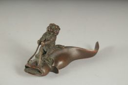 A LARGE JAPANESE BRONZE BEAR RIDING A FISH. 4.5ins long.